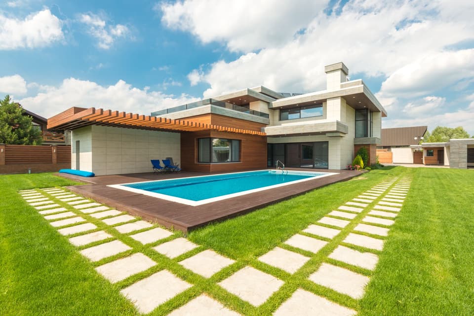 A backyard pool kept swim-ready with a clear-sky view.