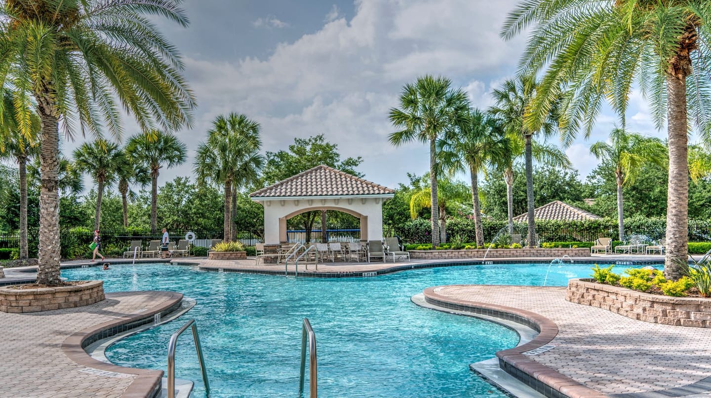 Clear blue pool beside a landscaped backyard